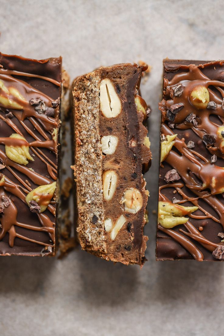 three pieces of chocolate cake with nuts on top