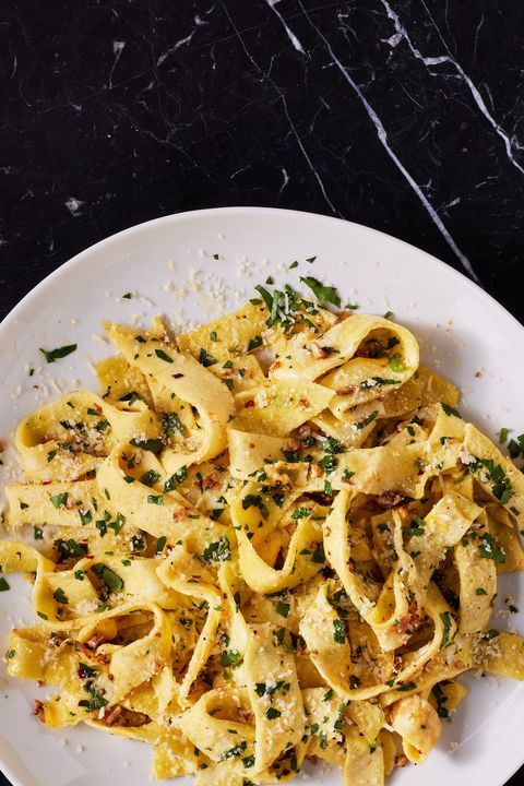 a white plate topped with pasta covered in sauce