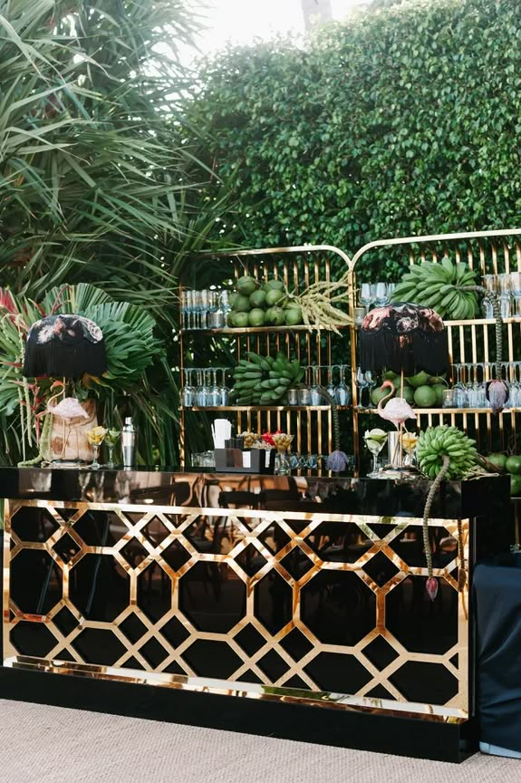 a gold and black bar with lots of plants on it next to a wall covered in greenery