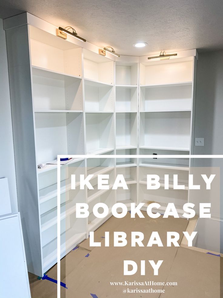 an empty room with white bookcases and blue tape on the floor