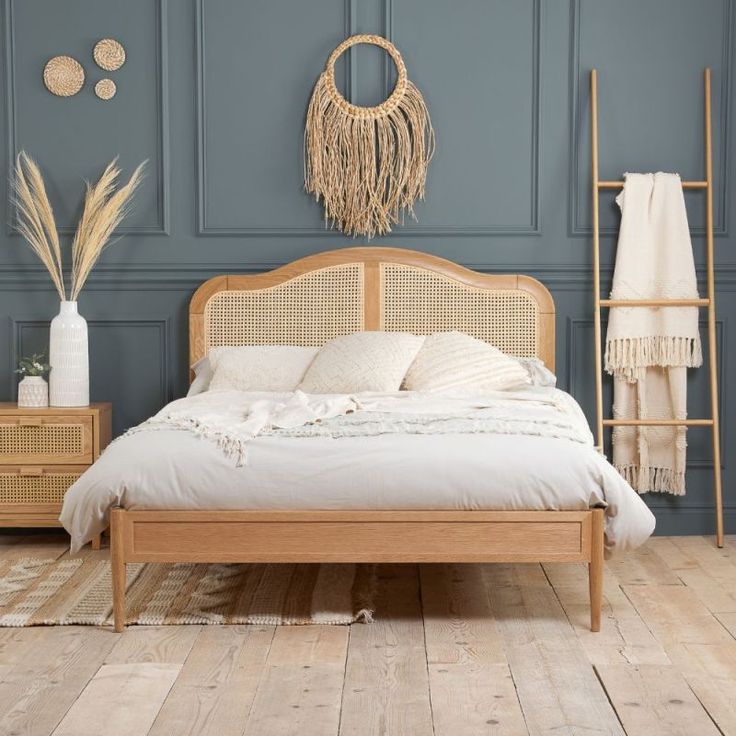 a bedroom with blue walls and white bedding