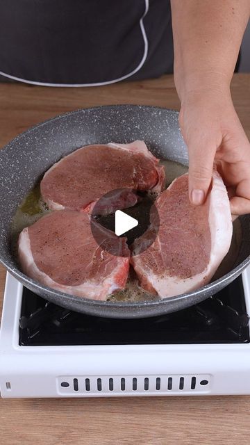 a person cooking meat in a skillet on top of a stove with an electric burner