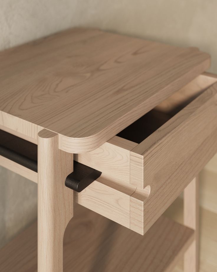 a close up of a wooden table with two drawers on one side and an open drawer on the other