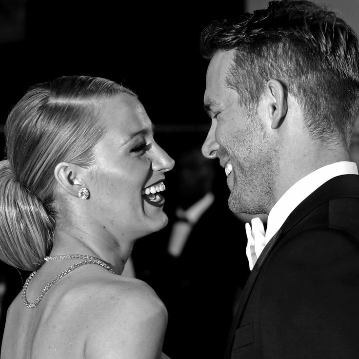 a man and woman are laughing together at an event