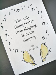 two yellow birds sitting on top of a white sheet with musical notes in the background