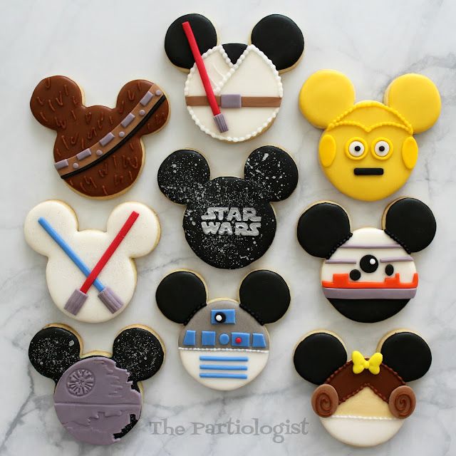 mickey mouse, star wars, darth vader and other decorated cookies on a marble surface