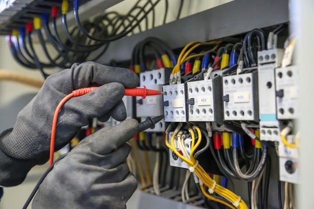 an electrician is working on the electrical panel