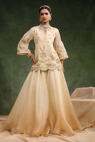 Beige short kurta with placement floral embroidery and scallop border hem. Paired with ombre flared sharara. - Aza Fashions Wedding Palazzo Set With Floral Embroidery In Raw Silk, Traditional Tissue Silk Sharara With Floral Embroidery, Floral Embroidered Tissue Silk Sharara, Raw Silk Sharara With Floral Embroidery For Reception, Floral Embroidered Raw Silk Sharara For Receptions, Fitted Embroidered Tissue Silk Palazzo Set, Fitted Floral Embroidered Tissue Silk Sharara, Fitted Tissue Silk Sharara With Chikankari Embroidery, Fitted Silk Sharara With Floral Embroidery