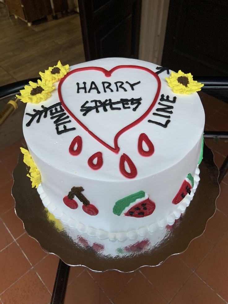 a heart shaped cake with the words harry potter written on it and sunflowers