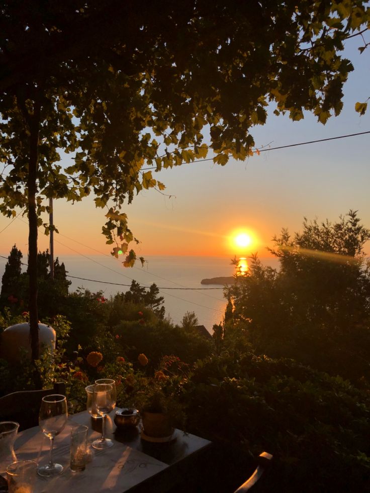 the sun is setting over an outdoor dining area