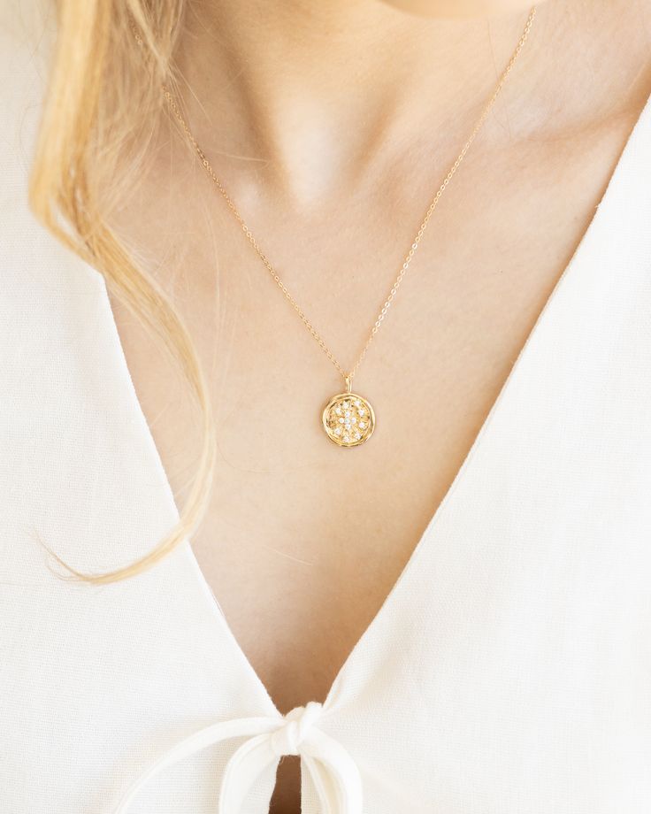 Indulge in celestial vibes with our Celeste Necklace. The gold medallion coin adds a touch of old money luxury while the celestial stone detailing adds a mystical touch. Perfect for adding a touch of gold to any outfit. Details: -Gold Filled -18" length -Waterproof, tarnish free, hypoallergenic -Bright White CZ Stones Gold-tone Medallion Necklace With Coin Pendant, Celestial Medallion Necklace With Adjustable Chain, Elegant Medallion Necklace With Coin Pendant, Gold Engraved Goddess Necklaces, Gold Engraved Goddess Style Necklaces, Spiritual Yellow Gold Coin Necklace With Adjustable Chain, Gold Engraved Goddess Jewelry, Gold Engraved Goddess Necklace, Gold Engraved Goddess Style Jewelry