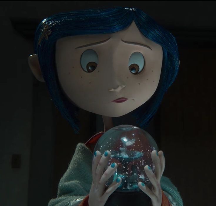 a close up of a person holding a glass ball in front of their face with blue hair