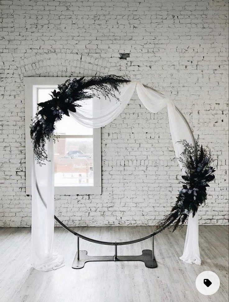 a white brick wall with a black and white wedding arch