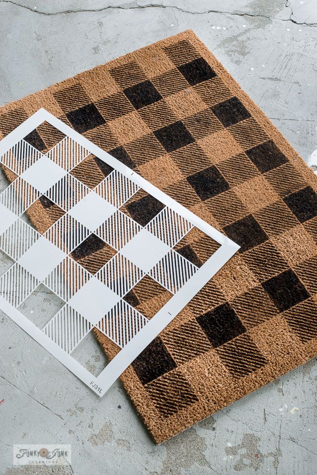 a brown and black rug sitting on top of a floor next to a piece of paper