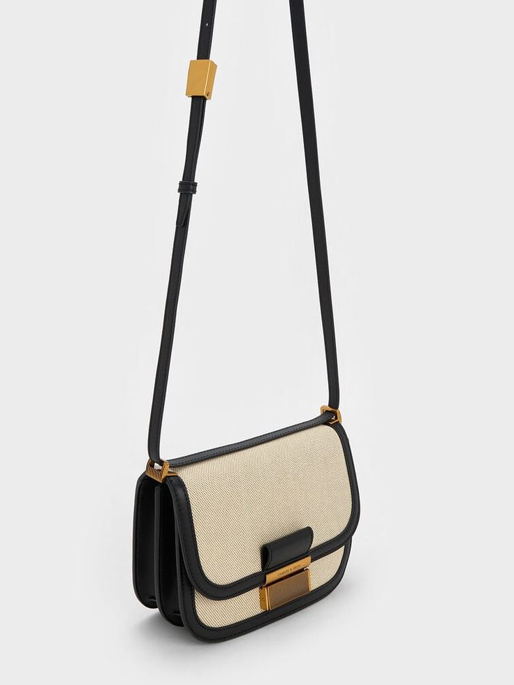 This product is made with at least 20% sustainable materials by weight. CHARLES & KEITH uses recycled, degradable, organic, and water-based materials in our eco-conscious collection. Updating the favourite Charlot crossbody bag with a lightweight and durable canvas finish, this chic carryall is the ideal style companion for days at the beach, weekend brunches, and everything in between. From the structured silhouette and tasteful curved corners to the classic black trim and gold-toned hardware, this bag is effortlessly stylish. Add a sophisticated finish to casual outfits with this beauty by your side. Charles And Keith Bags, Beach Weekend, Fancy Bags, Canvas Crossbody Bag, Pretty Bags, Charles Keith, Travel Wardrobe, By Your Side, Black Cross Body Bag