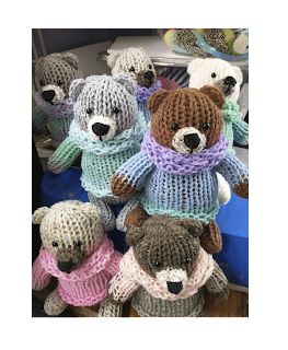 several knitted teddy bears in sweaters and scarves are sitting on top of each other