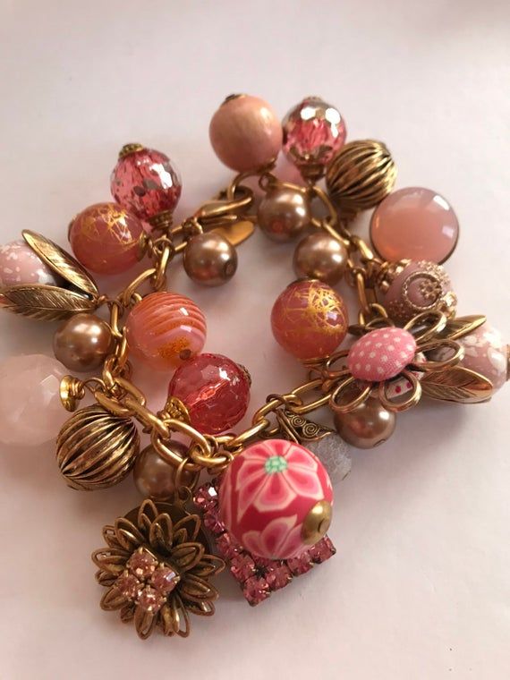 Lenora Dame charmingly pink baubly charm bracelet Pink Charm Bracelet With Colorful Round Beads, Whimsical Pink Bracelets With Colorful Beads, Pink Charm Bracelet With Colorful Beads, Pink Elegant Charm Bracelet, Elegant Pink Charm Bracelet With Round Beads, Pink Flower Charm Bracelet For Jewelry Making, Whimsical Pink Beaded Bracelets, Pink Whimsical Beaded Bracelets, Handmade Charming Pink Jewelry