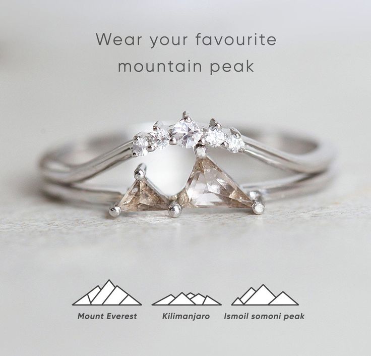 an advertisement for a mountain peak engagement ring with three pear shaped diamonds on each band