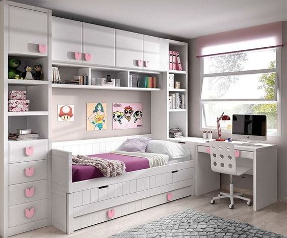 a child's bedroom with white furniture and pink accents on the walls, along with bookshelves