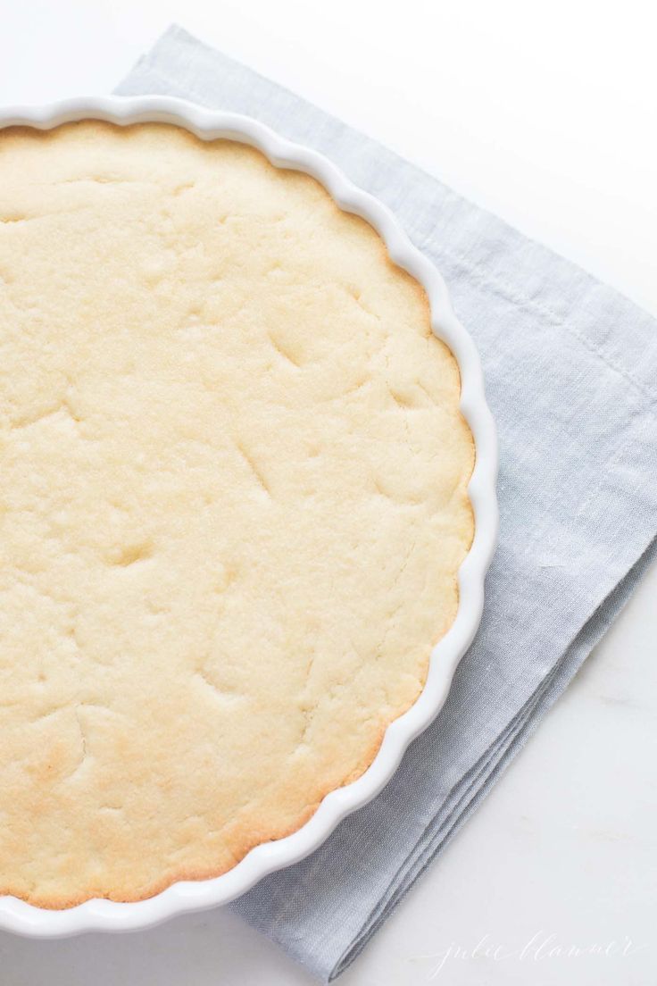 an uncooked pie sitting on top of a blue napkin