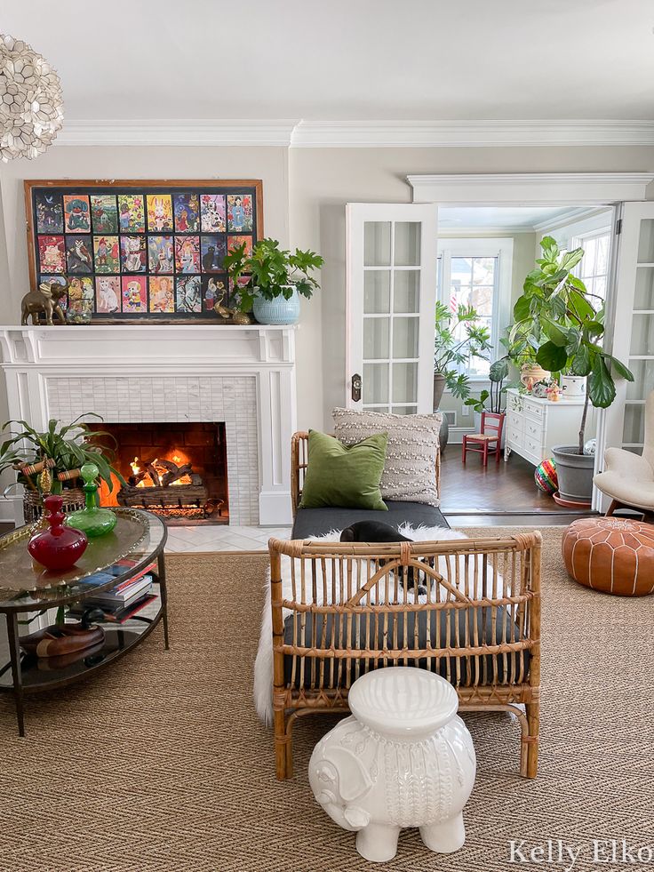 a living room filled with furniture and a fire place next to a fireplace covered in potted plants