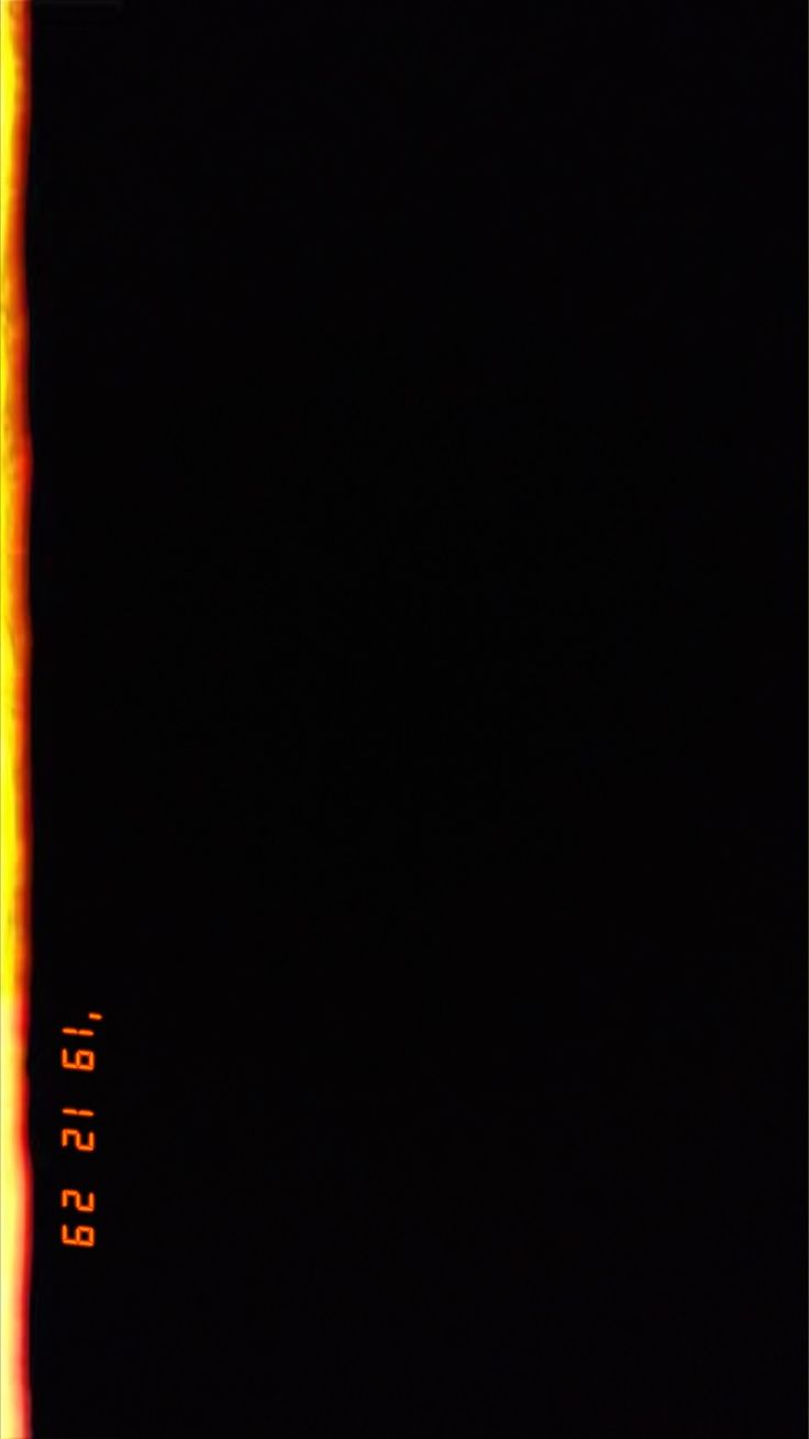 an orange and yellow line on the side of a black wall with words below it