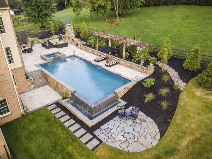 an aerial view of a backyard with a swimming pool