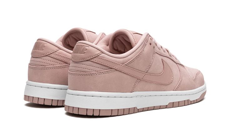 The Women’s Nike Dunk Low PRM “Pink Oxford” is a women’s-exclusive colorway of the retro basketball shoe with a mostly monochromatic pink appearance.  This Dunk Low features a pink nubuck construction with tonal overlays and Swoosh branding on the sides.  Tonal “Nike” branding appears on the tongue tag and heel.  A white rubber midsole adds contrast to the look, and a Pink Oxford outsole finishes off the shoe’s design.  Release date: April 22, 2023 Pink Oxford Shoes, Monochromatic Pink, Nike Dunks Low, Dunks Low, Low Dunks, Retro Basketball Shoes, Nike Branding, Retro Basketball, Oxford White