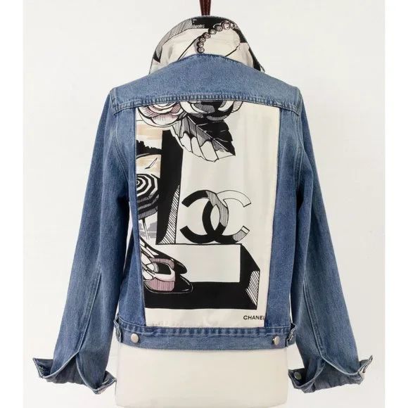 a jean jacket with an image of the letter g on it, hanging from a mannequin's dummy