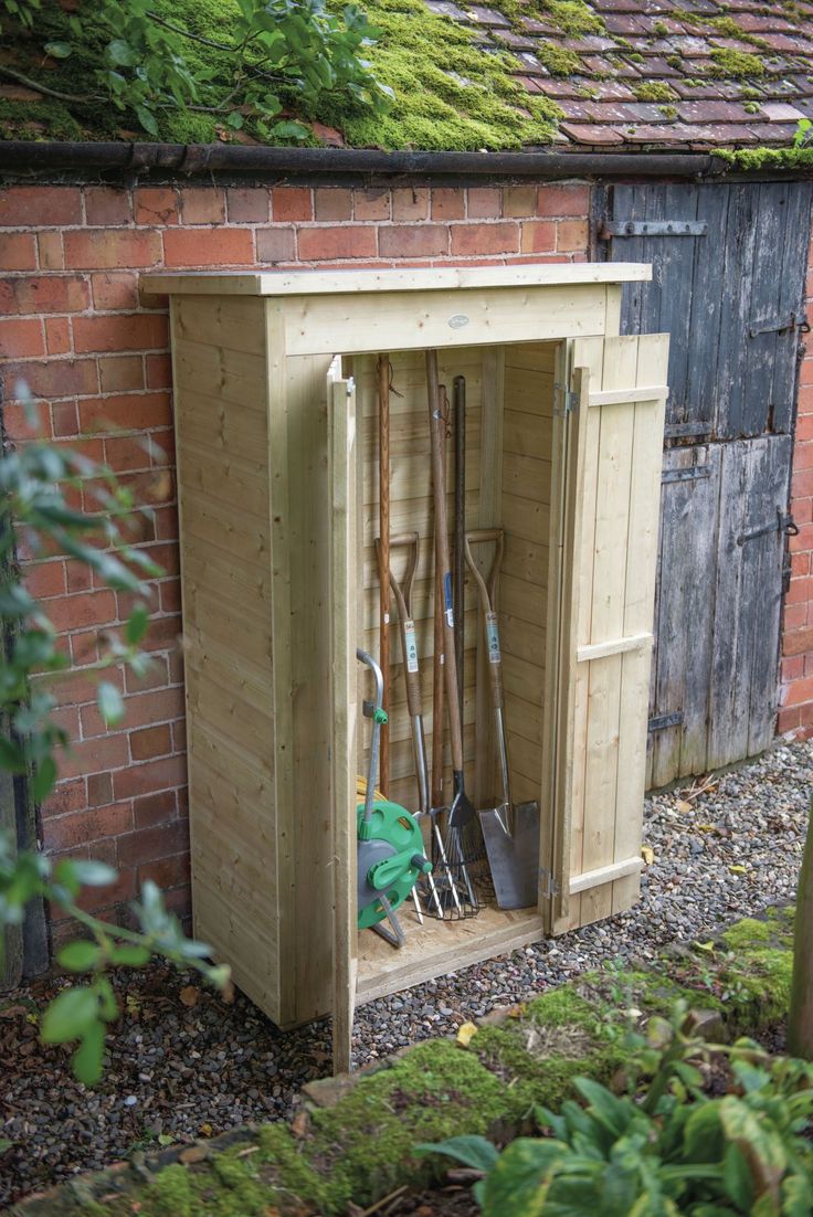 a garden shed with gardening tools in it