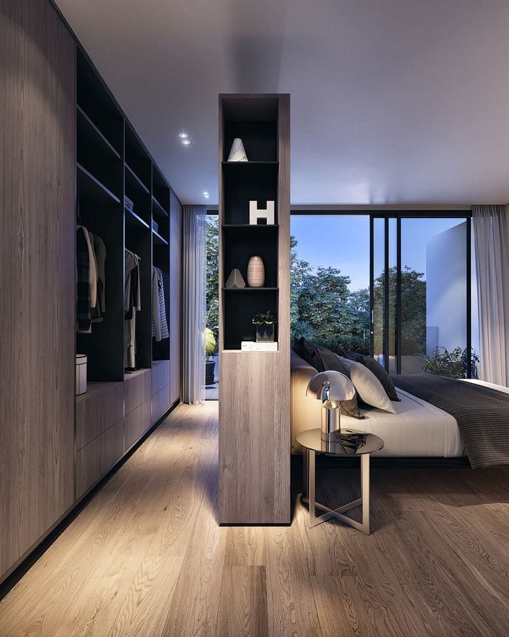 a bedroom with wooden floors and built - in shelving units, including a bed