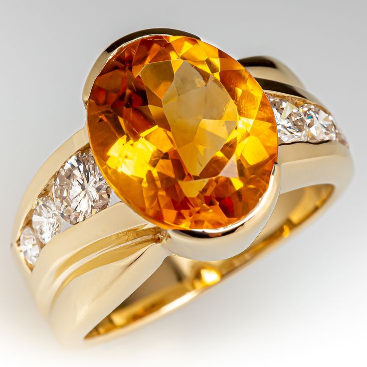 This pretty ring is centered with one (1) oval mixed cut natural citrine set into a semi-bezel setting. The shoulders of the ring are each accented with three (3), channel set, round brilliant cut diamonds. The ring measures 13.5mm at the top, rises 7.3mm above the finger, tapering to 4.1mm wide and 1.1mm thick at the base of the shank. This ring is currently a size 6. Citrine Ring Engagement, Vintage Cocktail Ring, Pretty Ring, Peridot Jewelry, Gold For Sale, Engagement Rings Bridal Sets, Alternative Engagement Rings, Vintage Cocktail, Natural Citrine