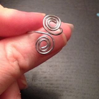 someone is holding their finger in front of the camera with two spirals on it