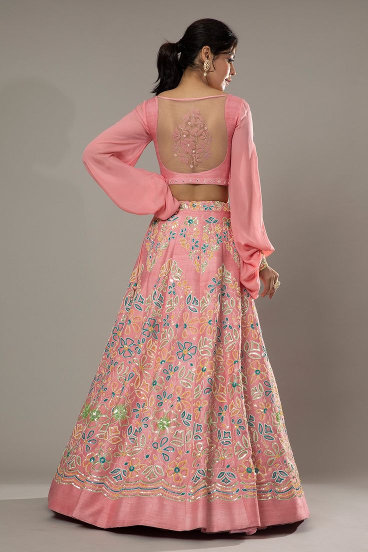 Candy floss pink raw silk lehenga with attached cancan, featuring hand embroidered floral puzzle patterns with cutdana and colorful sequins. Comes with embroidered padded blouse and dupatta.
Component: 3
Pattern: Hand Embroidered
Type Of Work: Floral Pattern, Sequins Cutdana
Neckline: Sweetheart
Sleeve Type: Puff Sleeve
Fabric: Raw Silk, Silk Organza
Color: Pink
Other Details: 
Floral patters
Embroidered cuffs
Back sheer panel
Approximate product weight: 4.5-5 Kg
Occasion: Bride, Wedding - Aza F Embroidered Cuffs, Raw Silk Lehenga, Padded Blouse, Candy Floss, Silk Lehenga, Silk Organza, Bridal Lehenga, Bride Wedding, Raw Silk