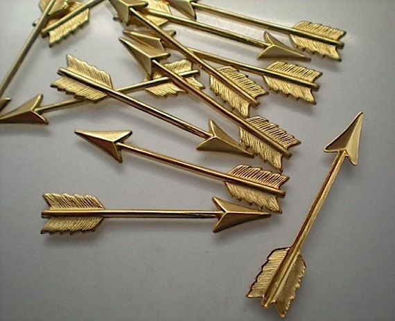 several gold colored arrows on a white surface