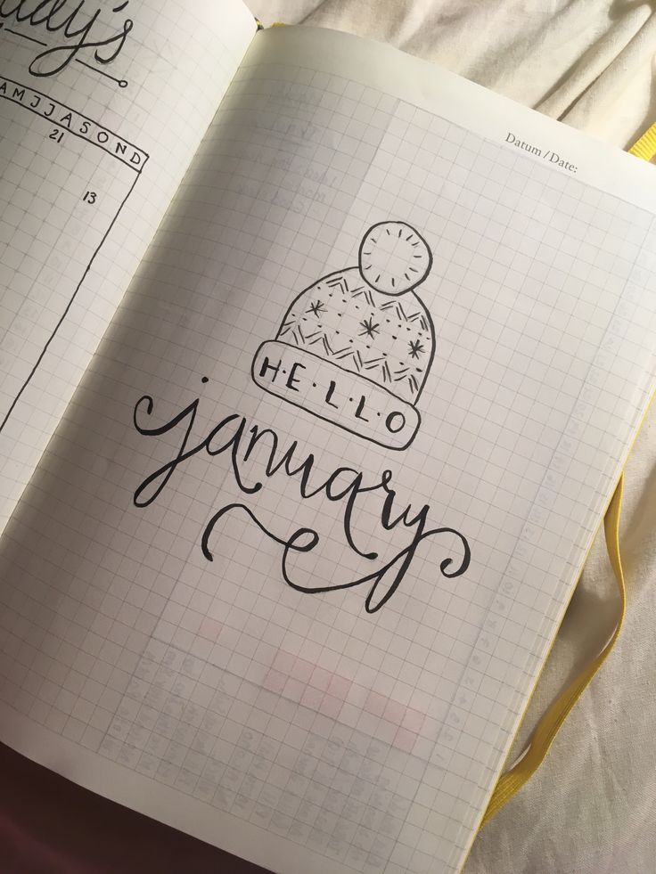 an open notebook with the words hello january written in cursive writing