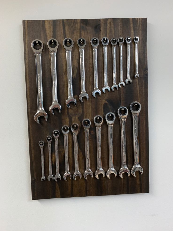 a bunch of wrenches hanging on a wall