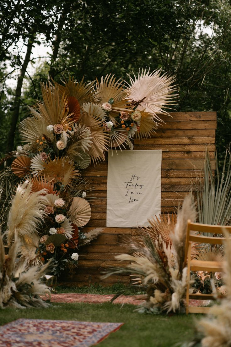 an outdoor ceremony setup with flowers and feathers