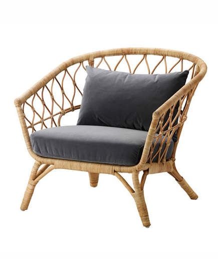 a wicker chair with grey cushion and pillow