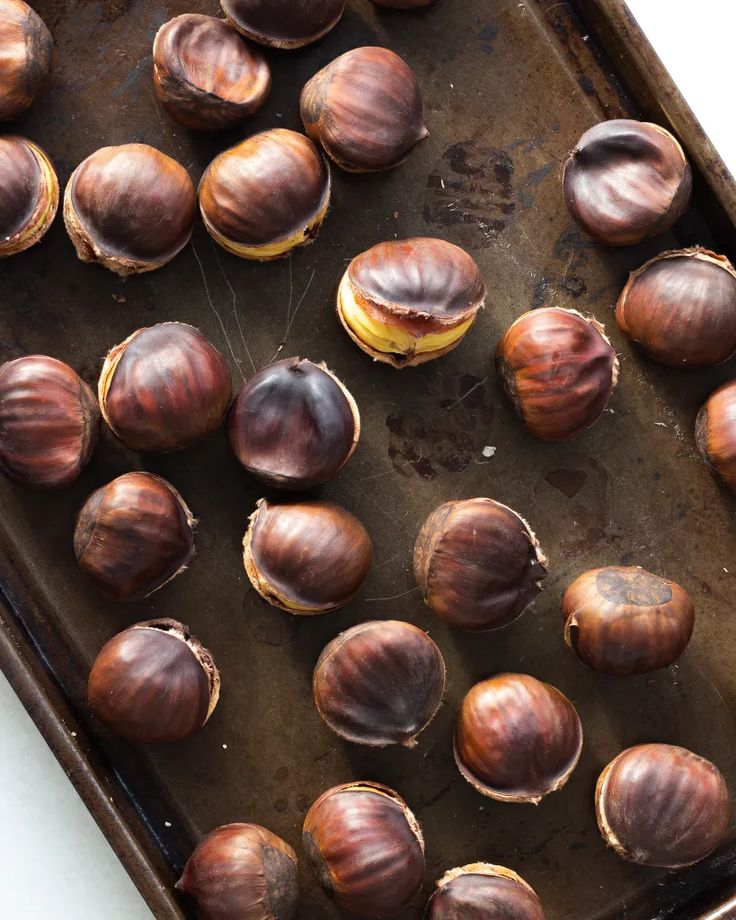 some chestnuts are sitting on a baking sheet