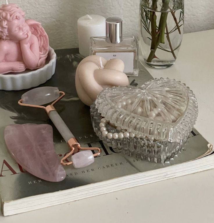 a table topped with candles, soaps and other items on top of a book