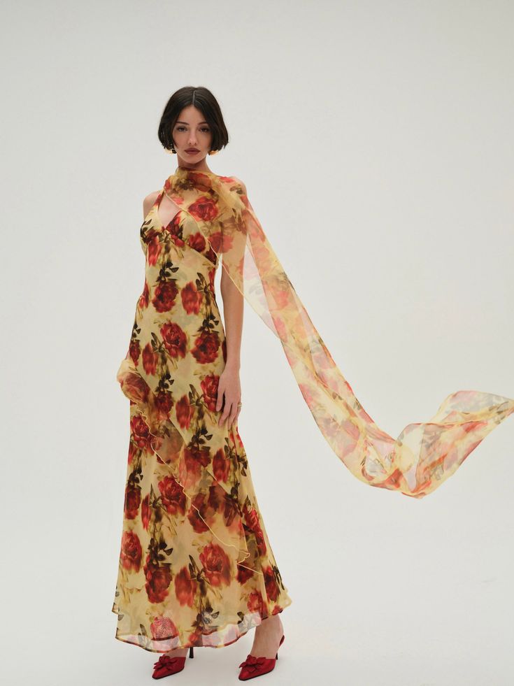 Inspired by vintage gowns, the Floral Stems yellow maxi dress spotlights an exquisite abstract rose print on delicate chiffon and organza. Cut to a plunging neckline, and featuring a low, open backthis long floral dress is decorated with cascading ruffles and a built-in shawl that you can throw over your shoulders for an elegant finish. Consider it the perfect wedding guest dress for the season's upcoming weddings. Dress With Shawl Wedding Guest, Dresses With Shawls, Shawl Wedding Guest, Floral Dress Long Sleeve, Art Color Palette, Floral Dress Long, Beach Bach, Perfect Wedding Guest Dress, Abstract Rose