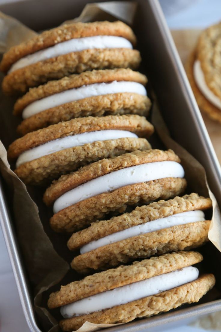 cookies with white icing in a tin on a table