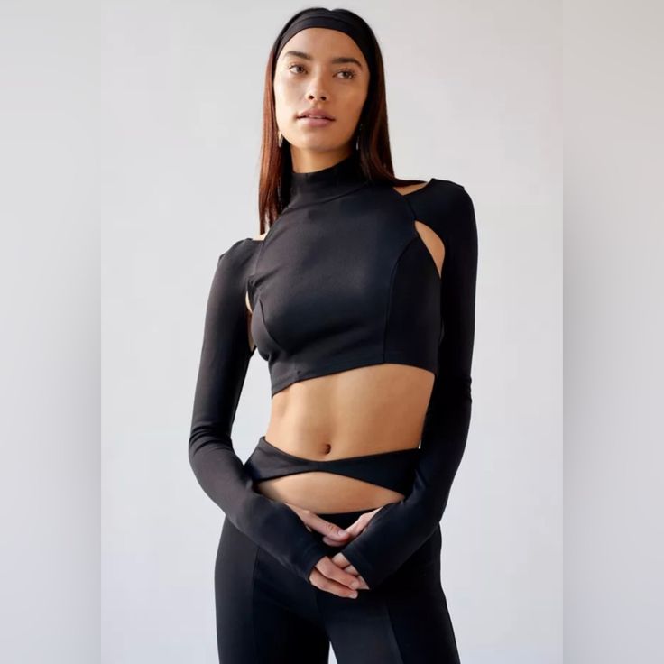 Urban Outfitters Two Piece Bombshell Cutout Cropped Top And Pant Set. Size Small Long Sleeve Cropped Top And Pant Set From Uo With Cutout Detailing Throughout. Top Is Super Fitted With A Turtleneck Plus A Cropped Bodice And Cutouts At The Back And Front. Finished With Thumbholes At The Cuffs. Pants Are Cut With A High-Rise And Fitted Throughout With A Cutout At The Front And Complete With Split Hems. Features: -Matching Top And Pants From Uo With Keyholes Cutouts Throughout -Top Hits Above The W Versatile Fitted Black Crop Top, High Stretch Chic Black Crop Top, Fitted Workout Tops By Urban Outfitters, Urban Outfitters Fitted Workout Tops, Fitted Urban Outfitters Tops For Workout, Chic Black Stretch Crop Top, Versatile Black Crop Top For Night Out, Black Elastane Crop Top For Fall, Edgy Black Tops From Urban Outfitters