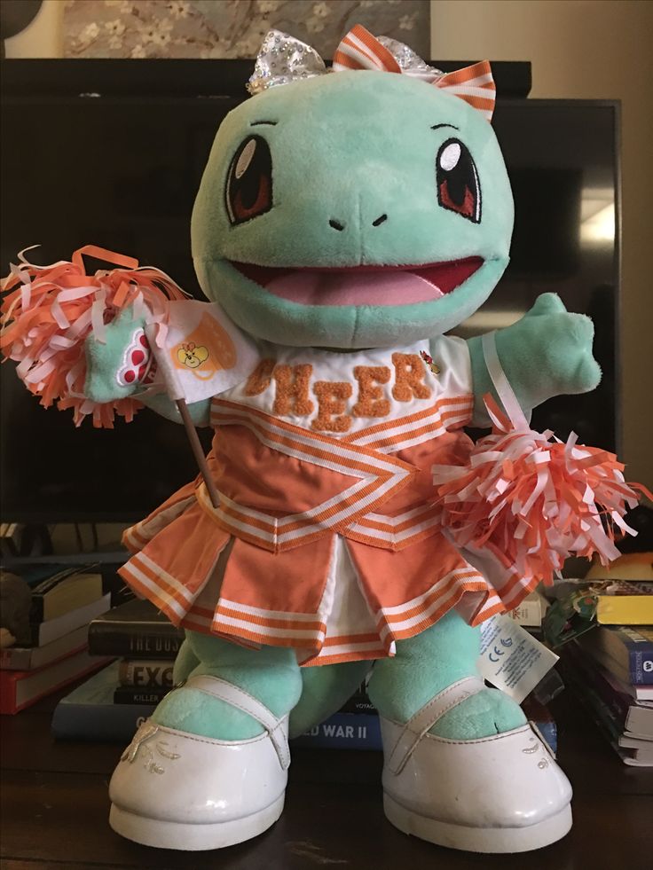 a stuffed animal that is wearing cheerleader clothes