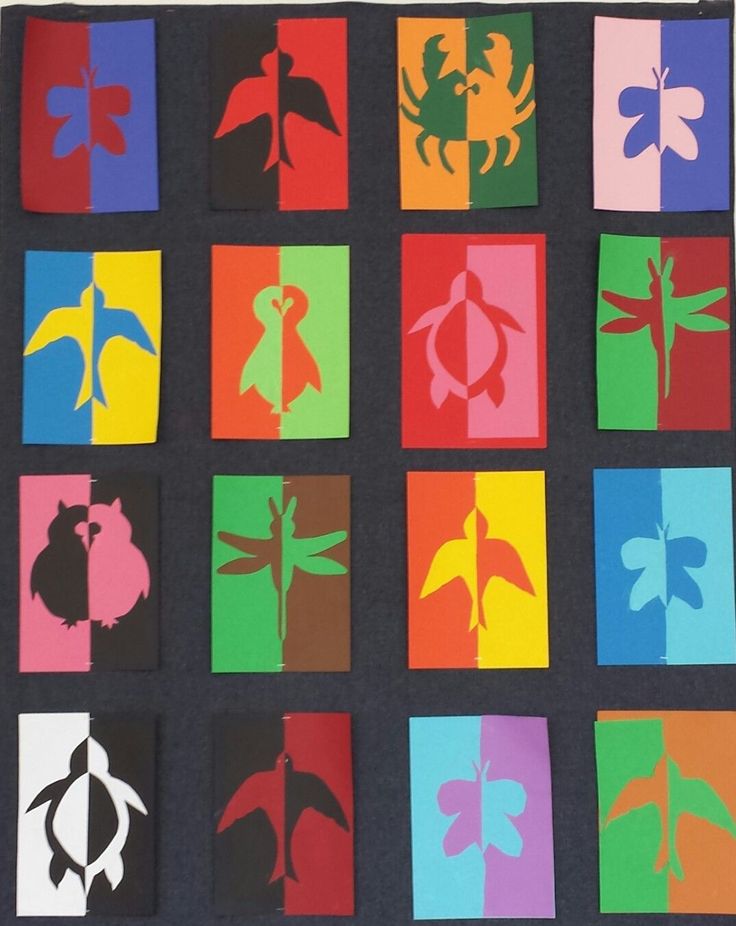 paper cut out with different colors and shapes on it, including leaves, flowers, and crabs