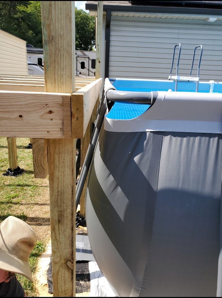 a boat with a cover on it is parked in the yard