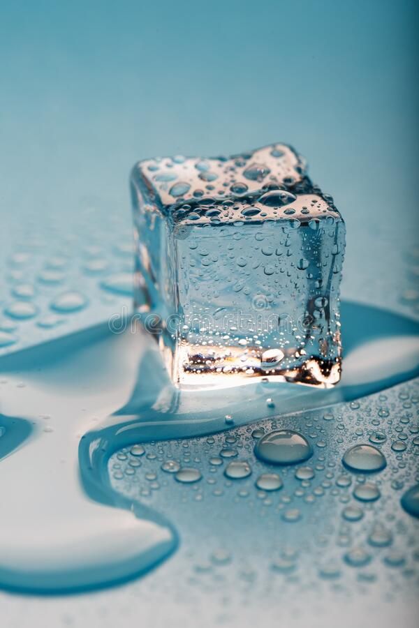 an ice cube with water drops on the surface stock photos, images and clippings