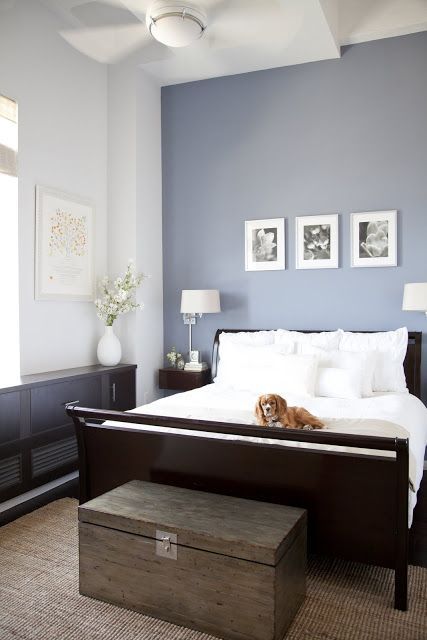 an image of a bedroom with blue walls and white bedding on the bottom floor