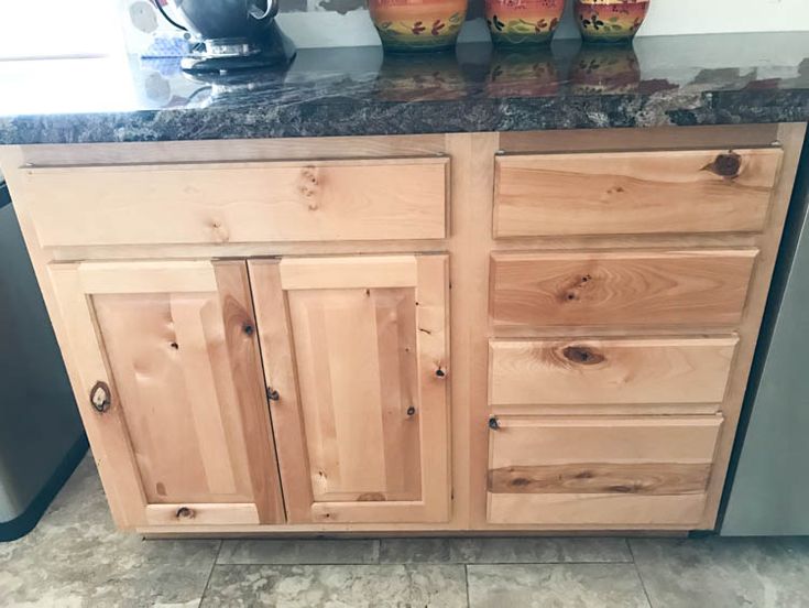 a kitchen with wooden cabinets and granite counter tops